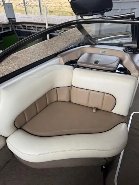 Slide: The Image of 2005 Malibu Sunsetter 23 XTi boat interior with beige and white seating. - 8