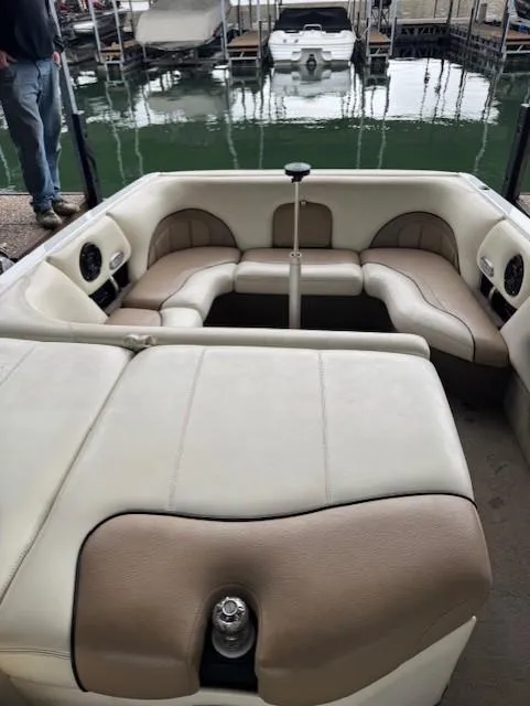 Slide: The Image of 2005 Malibu Sunsetter 23 XTi boat interior with beige seating and lake view. - 9