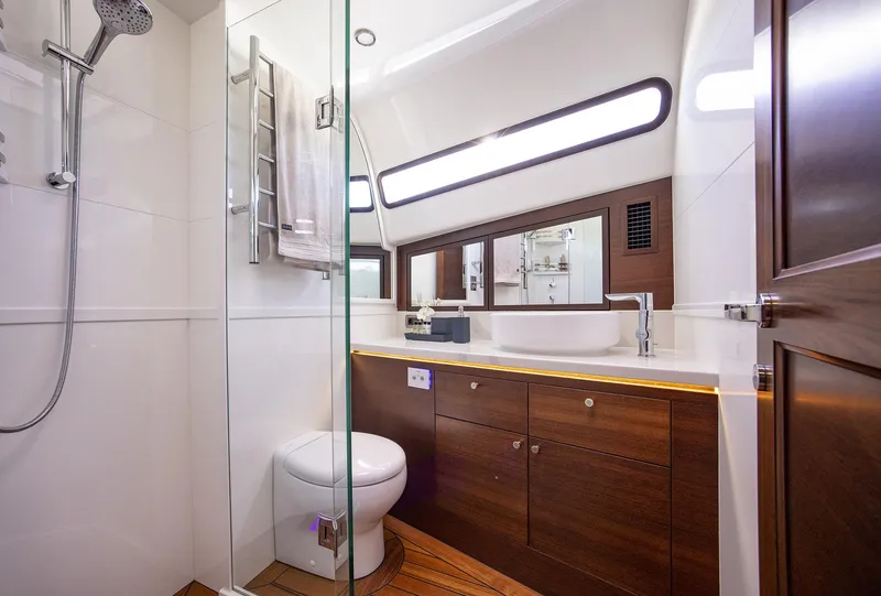 Slide: The Image of Luxurious bathroom in 2026 Grand Banks GB 85 yacht with modern fixtures and wooden cabinetry. - 10