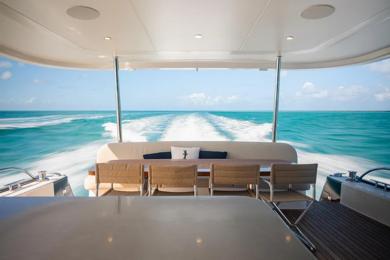 Slide: The Image of Luxury Grand Banks GB 85 yacht cruising on turquoise waters, 2026 model. - 2