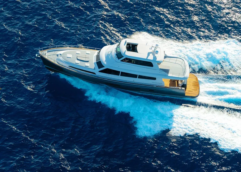 Slide: The Image of 2026 Grand Banks GB 85 yacht cruising on open blue sea. - 6