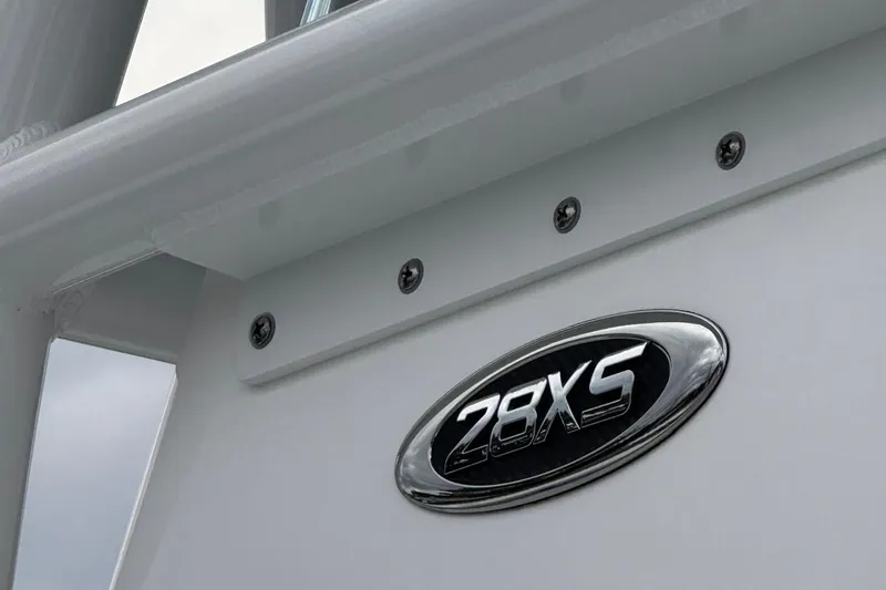 Slide: The Image of 2025 Cape Horn 28 XS boat emblem on sleek white surface. - 11