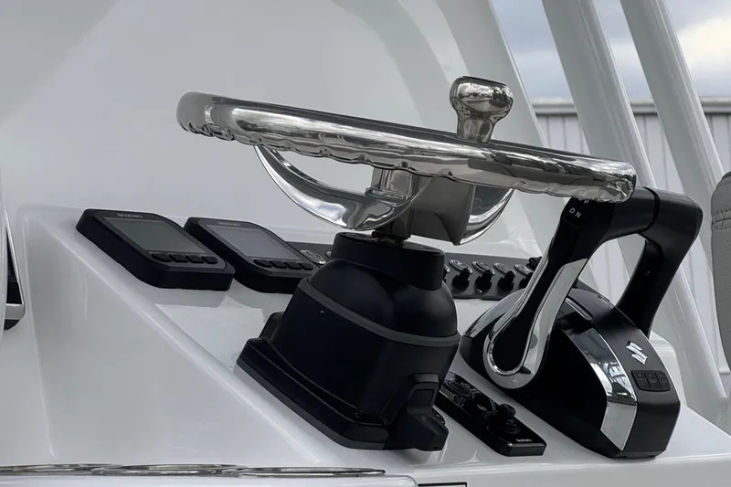 Slide: The Image of 2025 Cape Horn 28 XS boat helm with modern controls and steering wheel. - 12