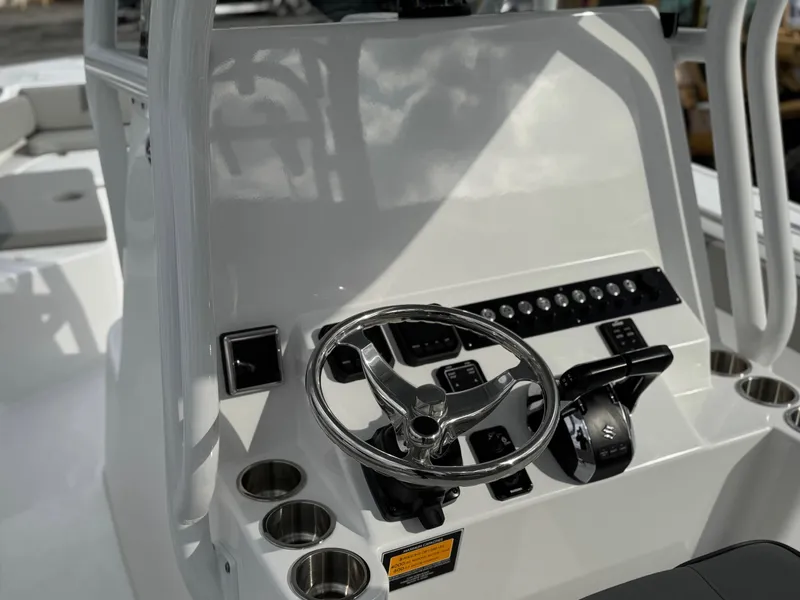 Slide: The Image of 2025 Cape Horn 28 XS boat console with steering wheel and controls. - 13