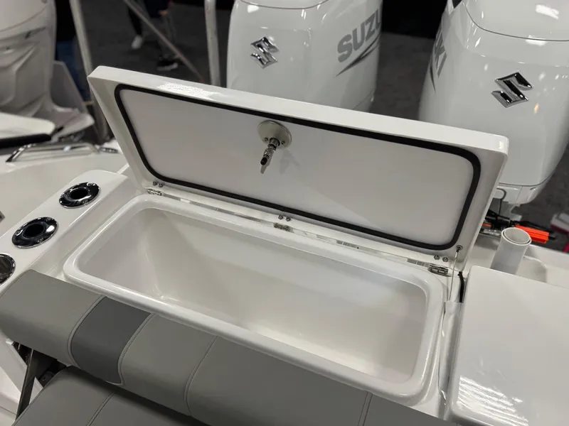 Slide: The Image of 2025 Cape Horn 28 XS boat with open storage compartment and Suzuki engines. - 17
