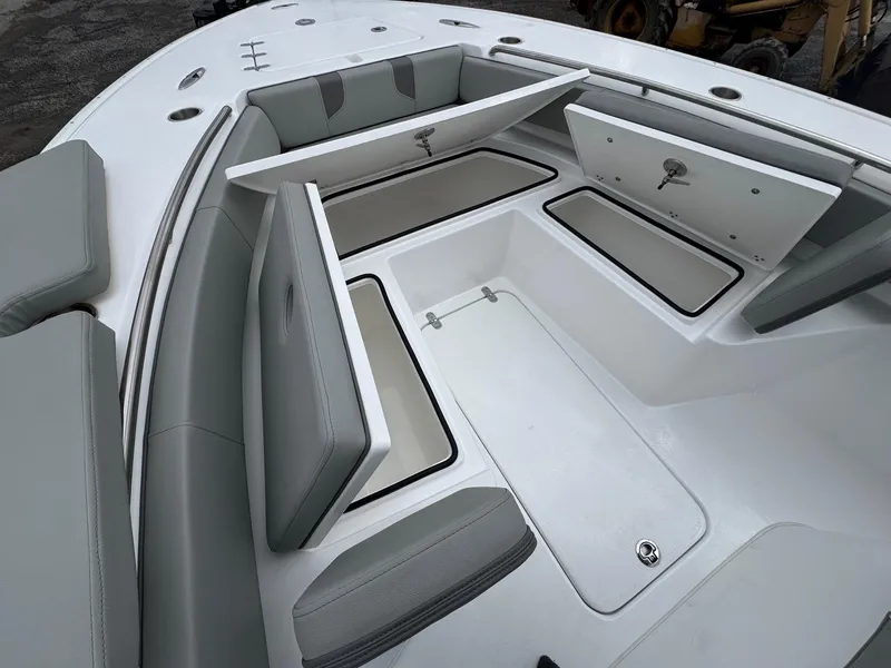 Slide: The Image of 2025 Cape Horn 28 XS boat with open storage compartments and cushioned seating. - 23