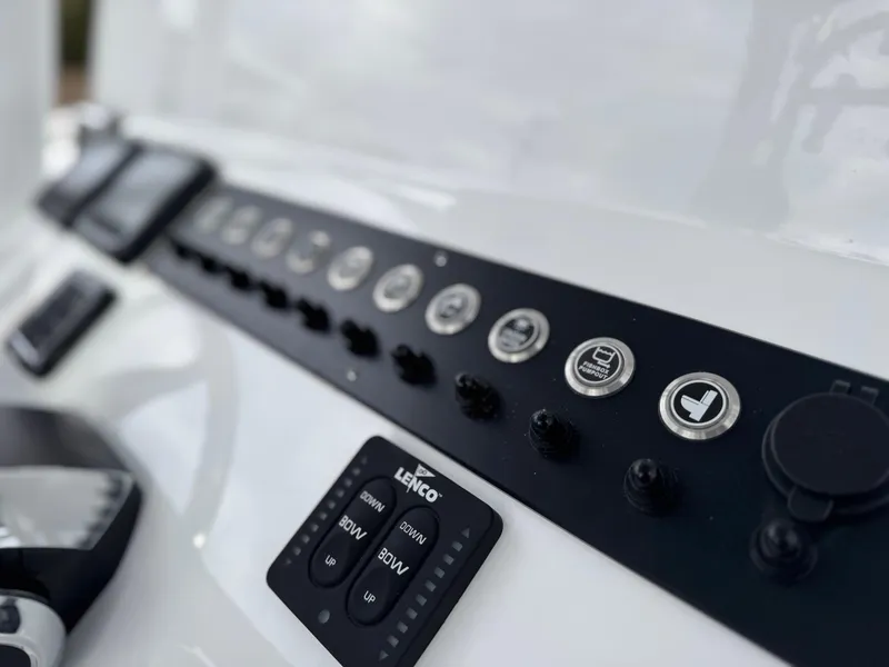 Slide: The Image of Control panel of 2025 Cape Horn 28 XS boat with buttons and switches. - 33