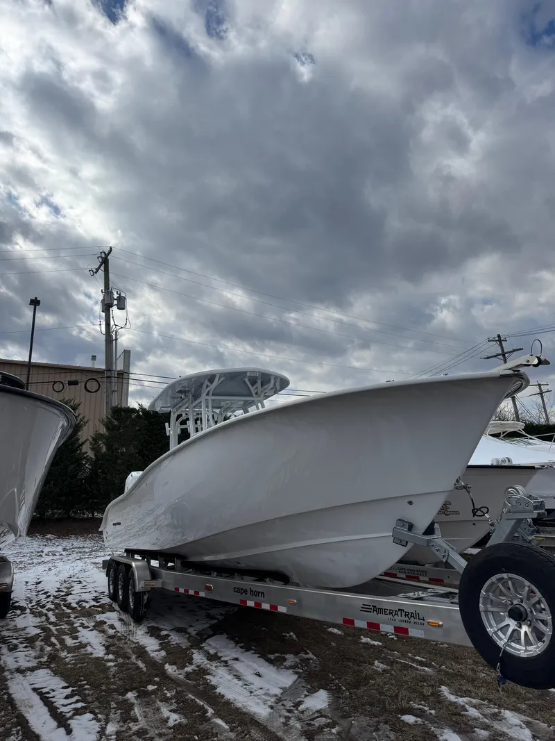 Slide: The Image of 2025 Cape Horn 28 XS boat on trailer under cloudy sky. - 37