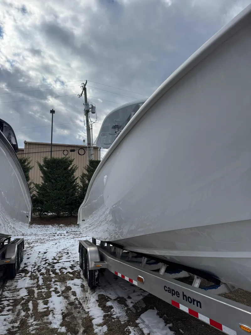 Slide: The Image of 2025 Cape Horn 28 XS boat on trailer, cloudy sky background. - 38