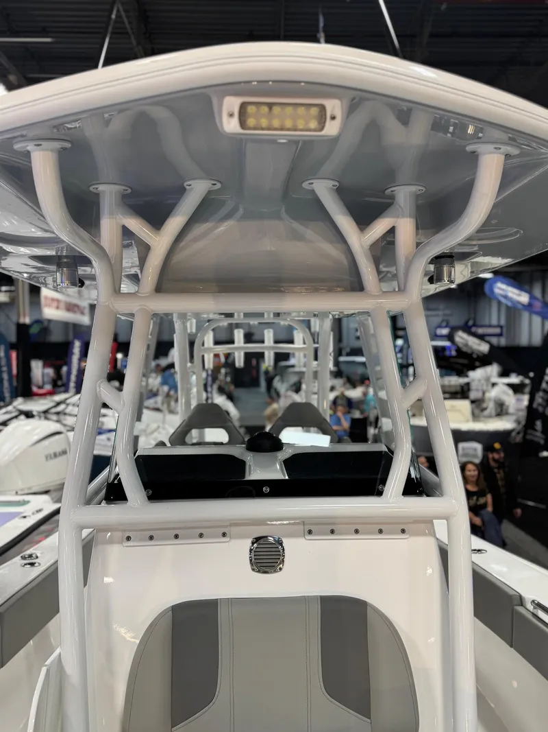 Slide: The Image of 2025 Cape Horn 28 XS boat interior with T-top and seating, showcased indoors. - 40