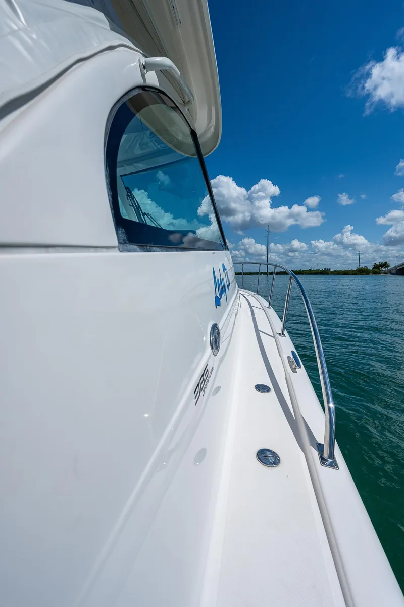 Slide: The Image of 2018 Pursuit OS 385 Offshore boat on water under blue sky. - 10