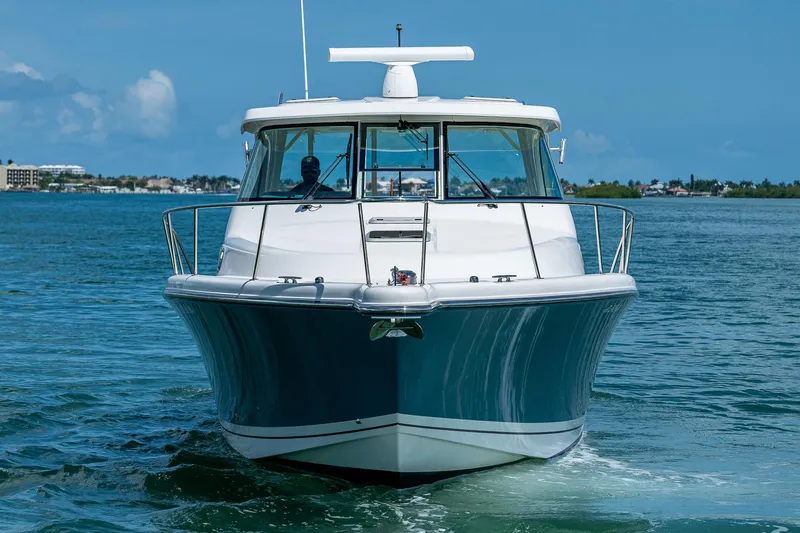 Slide: The Image of 2018 Pursuit OS 385 Offshore boat cruising on clear blue water. - 2