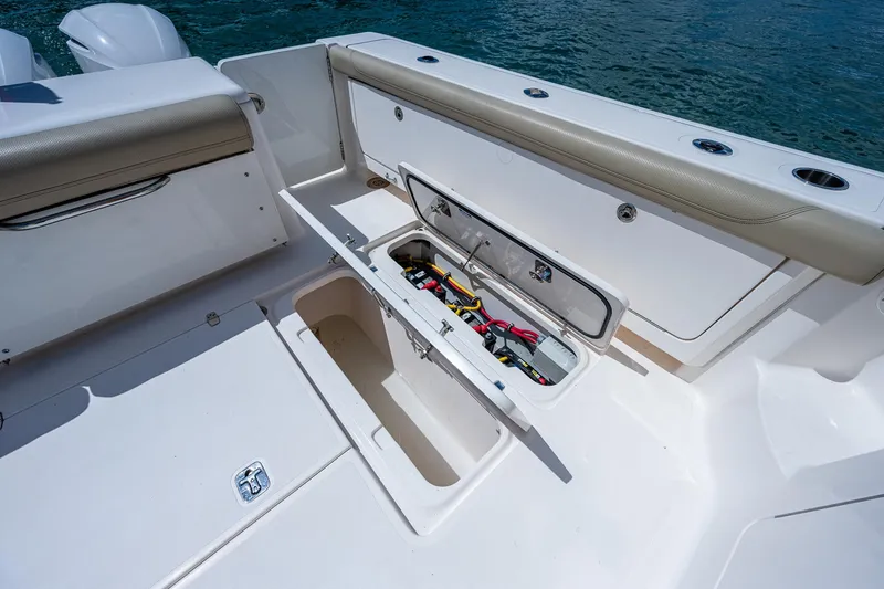 Slide: The Image of 2018 Pursuit OS 385 Offshore boat with open storage compartment, showcasing interior details. - 22