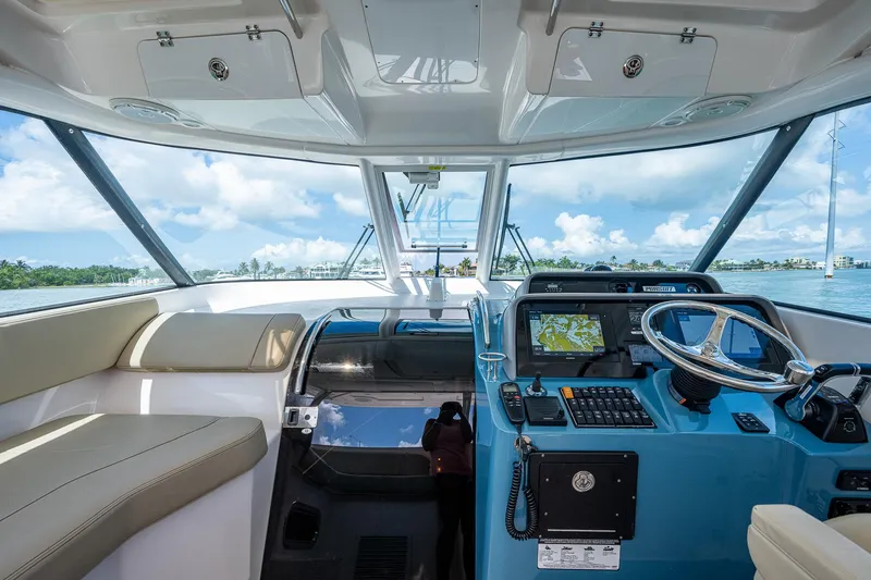 Slide: The Image of 2018 Pursuit OS 385 Offshore boat interior with modern helm and seating. - 27