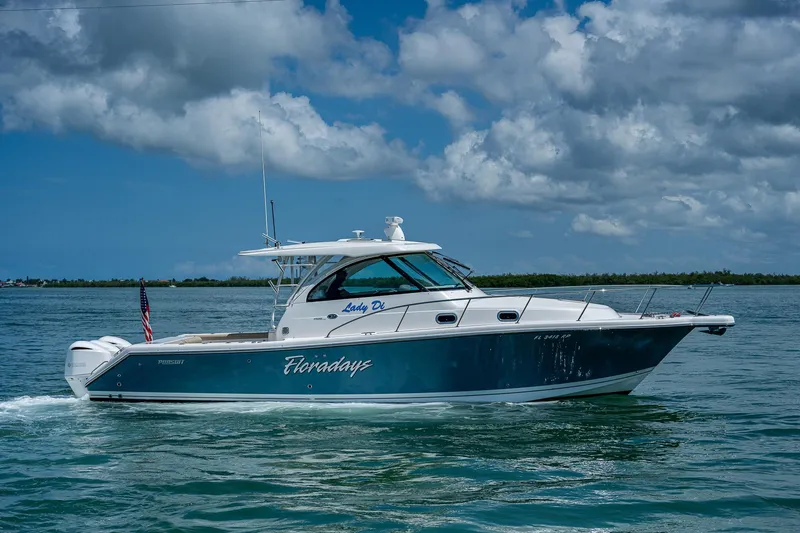 Slide: The Image of 2018 Pursuit OS 385 Offshore boat cruising on a sunny day with cloudy skies. - 3