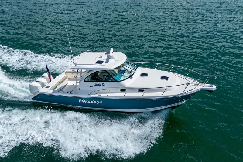 Slide: The Image of 2018 Pursuit OS 385 Offshore boat cruising on open water. - 4