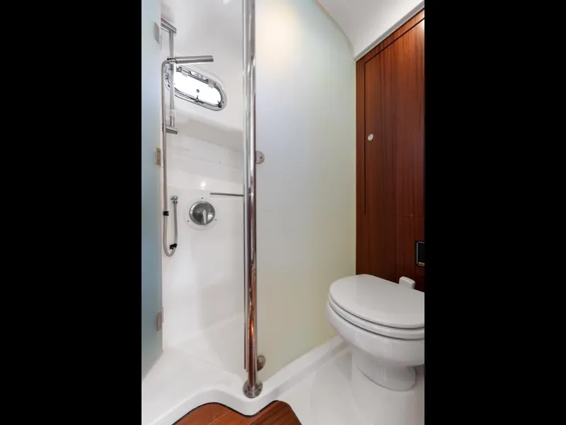 Slide: The Image of Bathroom interior of 2018 Pursuit OS 385 Offshore boat, featuring shower and toilet. - 48