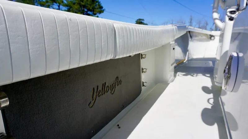 Slide: The Image of 2006 Yellowfin 34 Offshore boat interior with white seating and logo detail. - 22