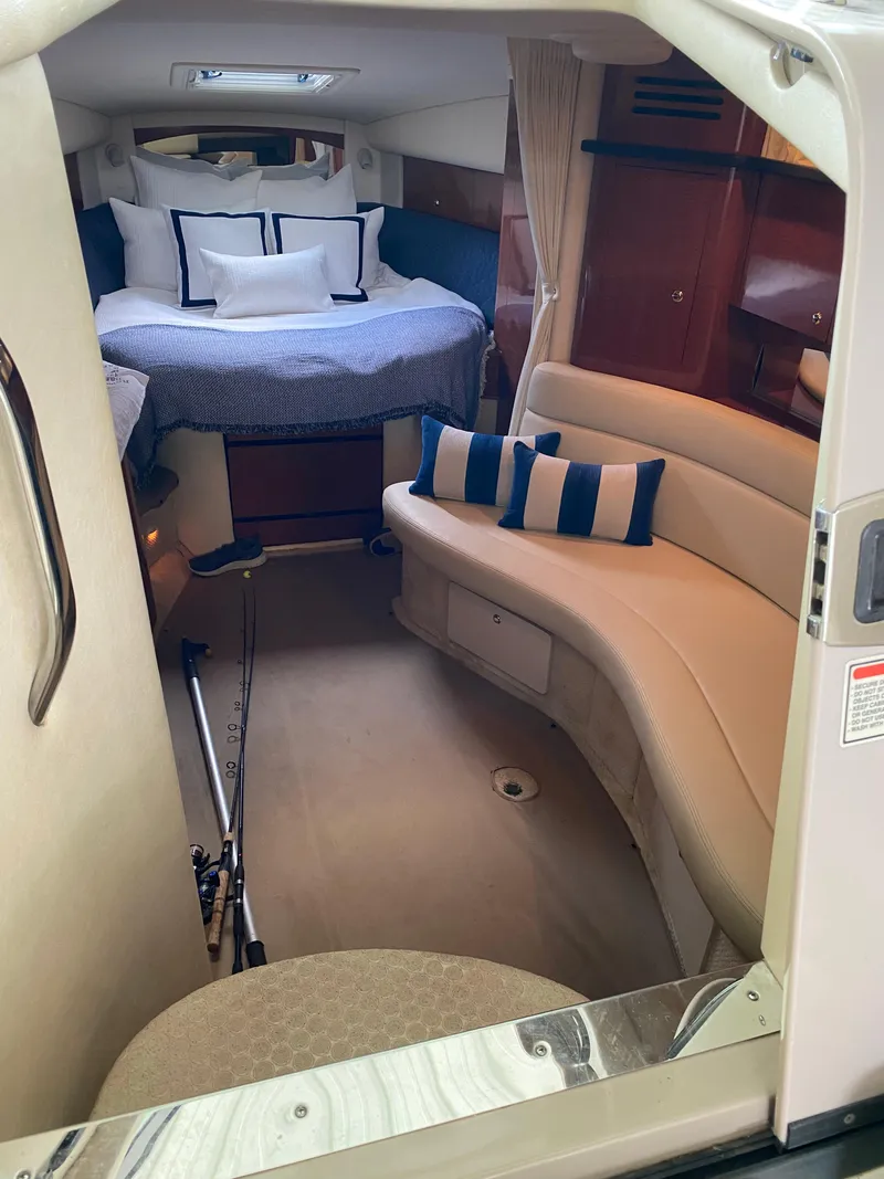 Slide: The Image of Interior of 2003 Sea Ray 320 Sundancer with cozy seating and bed. - 11
