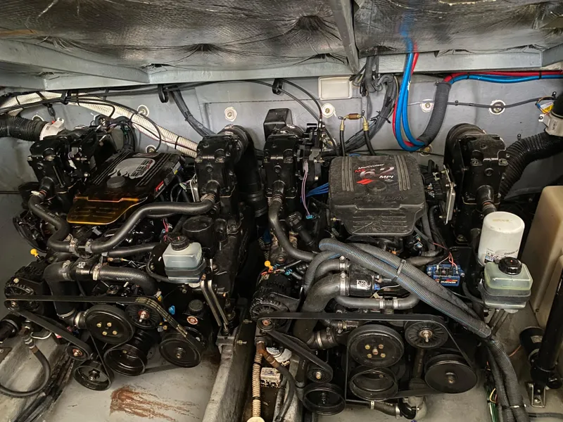 Slide: The Image of Engine room of a 2003 Sea Ray 320 Sundancer boat, showcasing dual engines. - 14
