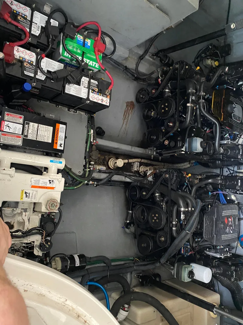 Slide: The Image of Engine compartment of a 2003 Sea Ray 320 Sundancer with visible batteries and mechanical components. - 16