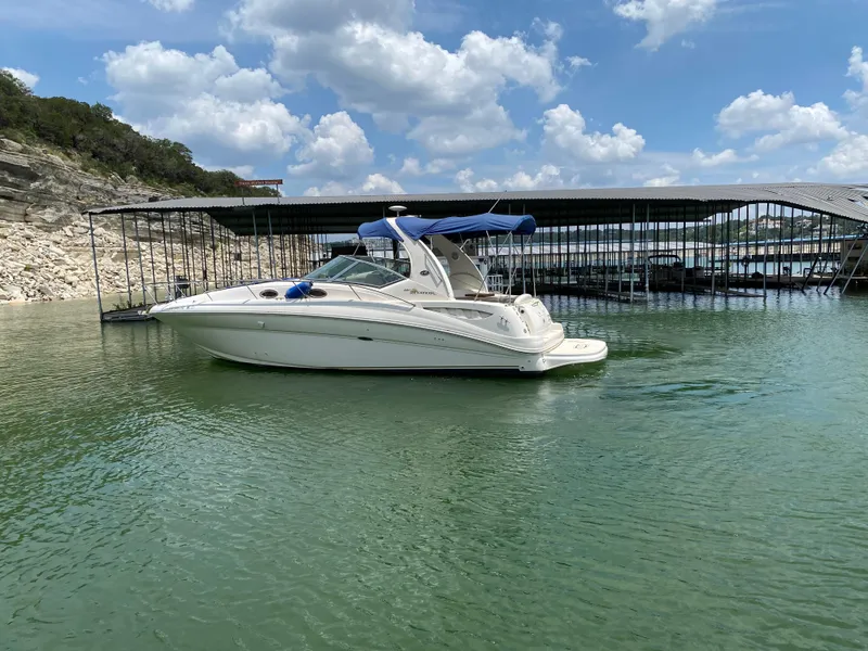 Slide: The Image of 2003 Sea Ray 320 Sundancer boat on calm water under a partly cloudy sky. - 4