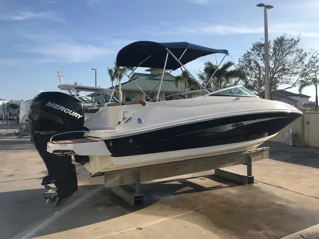Slide: The Image of 2015 Sea Ray 220 Sundeck Outboard boat with Mercury engine on a lift. - 11