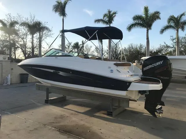 Slide: The Image of 2015 Sea Ray 220 Sundeck Outboard boat on display, featuring a Mercury engine. - 20