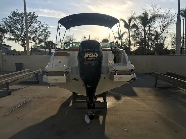Slide: The Image of 2015 Sea Ray 220 Sundeck Outboard boat with Yamaha 200 engine, docked at sunset. - 25