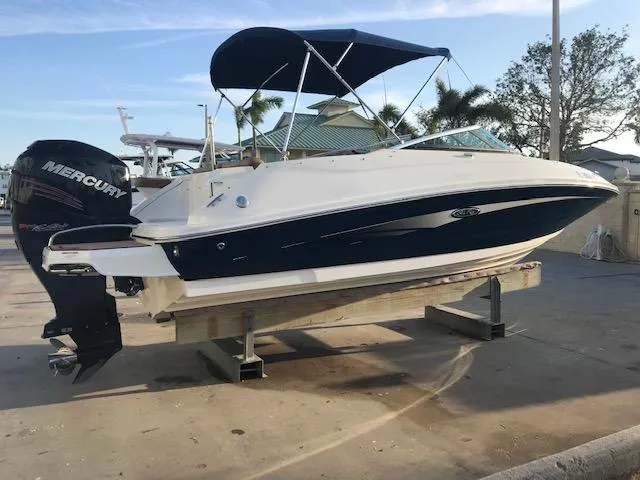 Slide: The Image of 2015 Sea Ray 220 Sundeck Outboard boat with Mercury engine on display. - 26