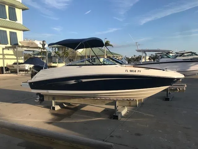 Slide: The Image of 2015 Sea Ray 220 Sundeck Outboard boat on display at marina. - 28