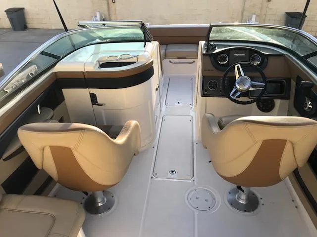 Slide: The Image of 2015 Sea Ray 220 Sundeck Outboard interior with dual captain seats and modern dashboard. - 35