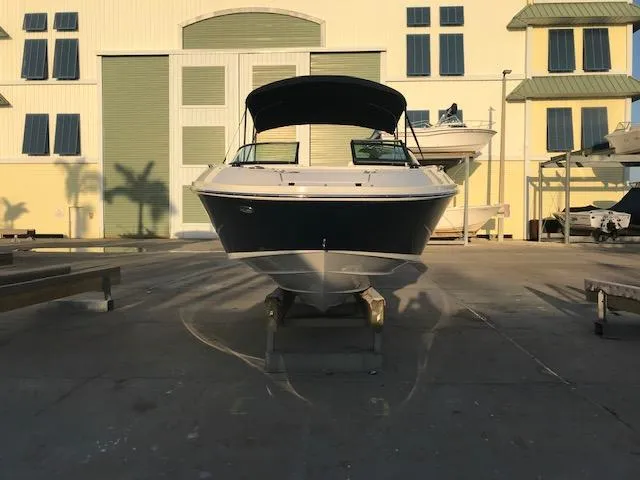 Slide: The Image of 2015 Sea Ray 220 Sundeck Outboard boat on display in a marina setting. - 6