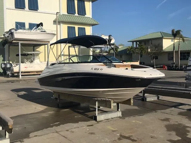 Slide: The Image of 2015 Sea Ray 220 Sundeck Outboard boat on a dock, sunny day, marina background. - 7