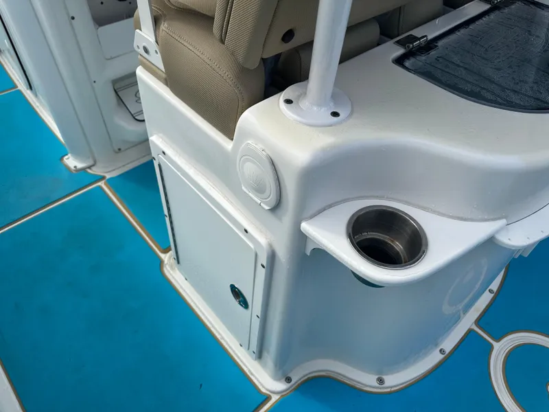 Slide: The Image of 2018 Sea Hunt 25 Gamefish boat interior with blue flooring and cup holder. - 14