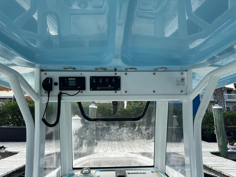Slide: The Image of 2018 Sea Hunt 25 Gamefish boat console with electronics and controls. - 15