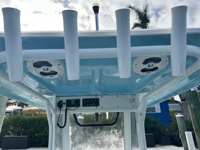 Slide: The Image of 2018 Sea Hunt 25 Gamefish boat with rod holders and electronic controls. - 16