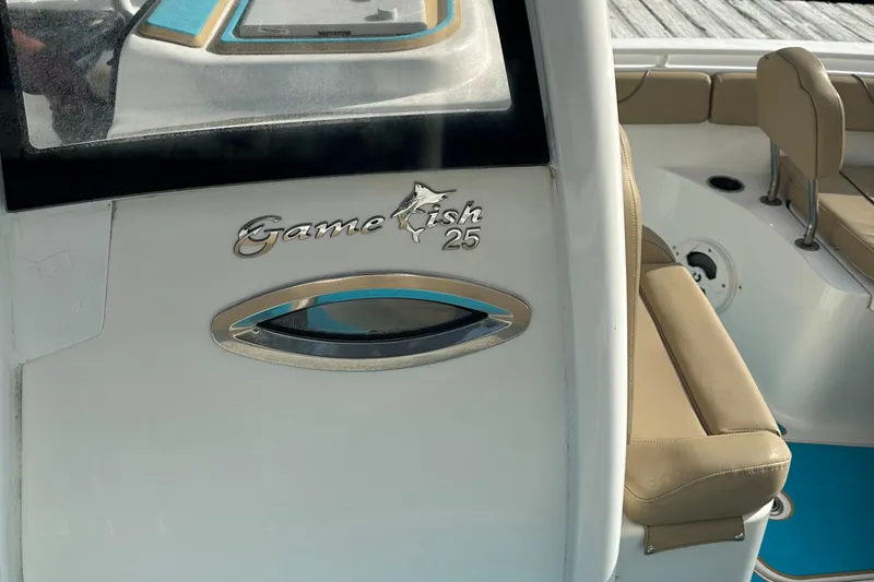 Slide: The Image of 2018 Sea Hunt 25 Gamefish boat interior with seating and logo detail. - 21
