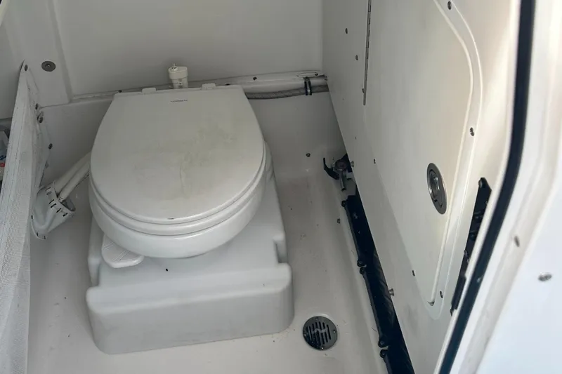 Slide: The Image of 2018 Sea Hunt 25 Gamefish boat toilet interior, featuring compact marine design. - 22