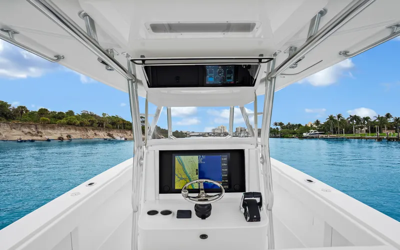 Slide: The Image of 2017 Bahama Center Console boat interior with navigation system on a scenic waterway. - 10