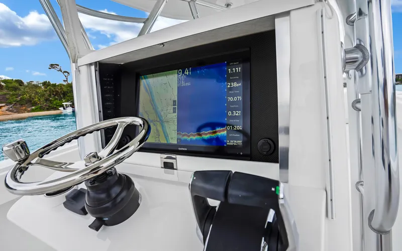 Slide: The Image of 2017 Bahama Center Console boat dashboard with navigation display and steering wheel. - 11