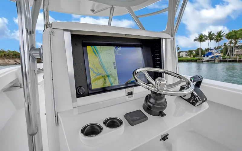 Slide: The Image of 2017 Bahama Center Console boat dashboard with navigation screen and steering wheel. - 13