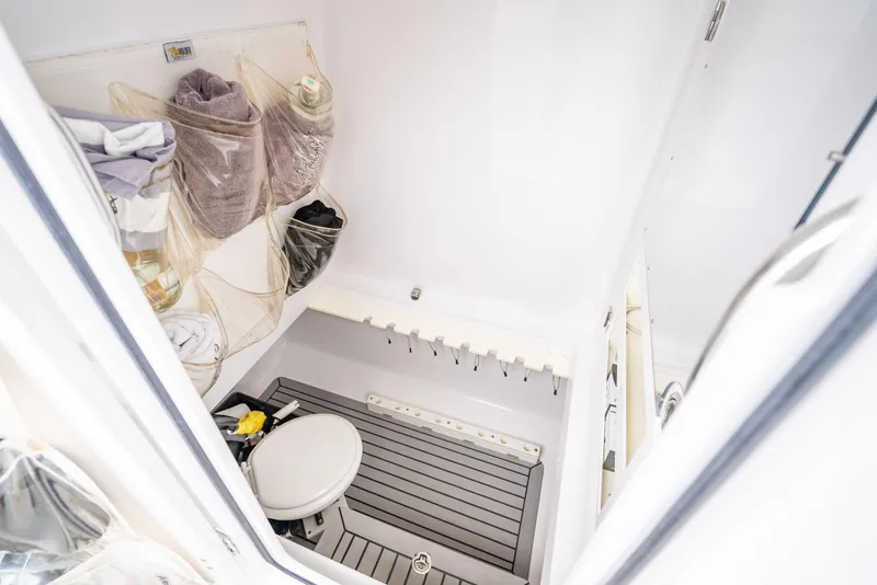 Slide: The Image of 2017 Bahama Center Console boat interior with storage and toilet. - 17