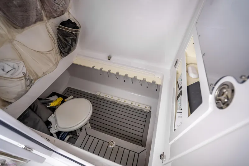 Slide: The Image of 2017 Bahama Center Console boat interior with toilet and storage area. - 18