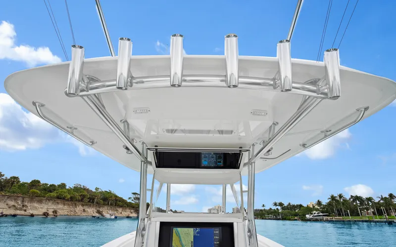 Slide: The Image of 2017 Bahama Center Console boat with T-top and navigation equipment, cruising on a sunny day. - 19