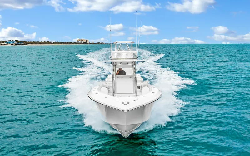 Slide: The Image of 2017 Bahama Center Console boat cruising on clear blue ocean waters. - 2