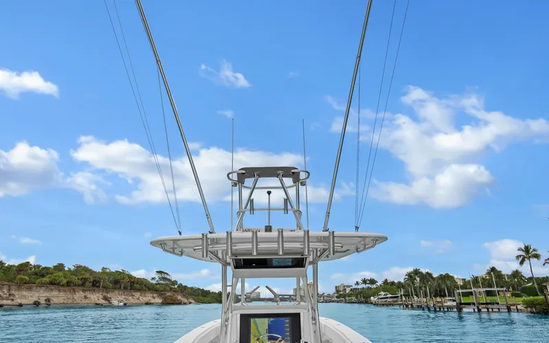 Slide: The Image of 2017 Bahama Center Console boat on a scenic waterway under a clear blue sky. - 20