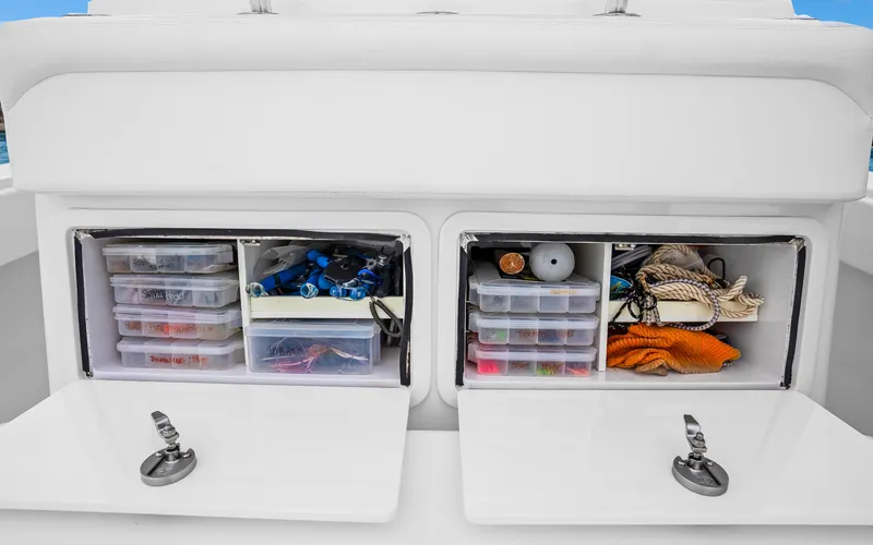 Slide: The Image of 2017 Bahama Center Console storage compartments with organized fishing gear and accessories. - 24