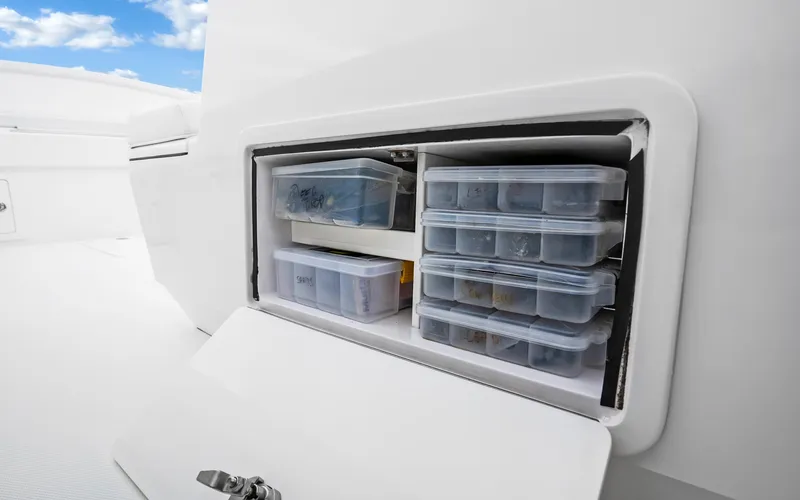 Slide: The Image of Storage compartment on 2017 Bahama Center Console boat with organized containers. - 25