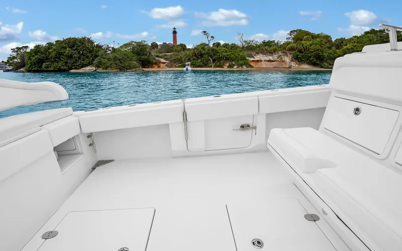 Slide: The Image of 2017 Bahama Center Console boat interior with scenic coastal view and lighthouse in the background. - 26